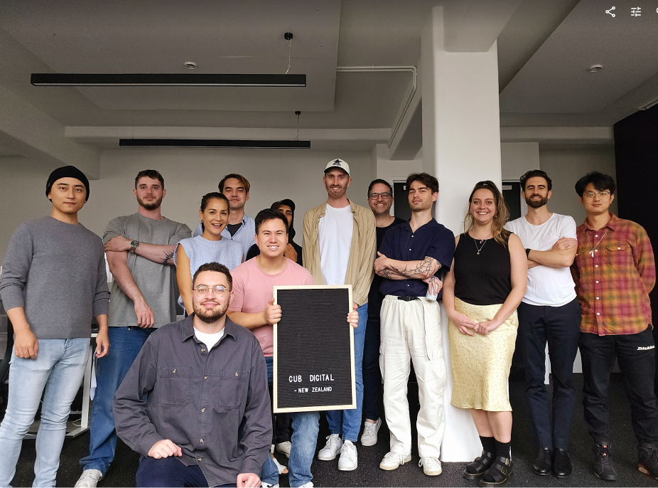 Group photo of the team holding a celebratory sign